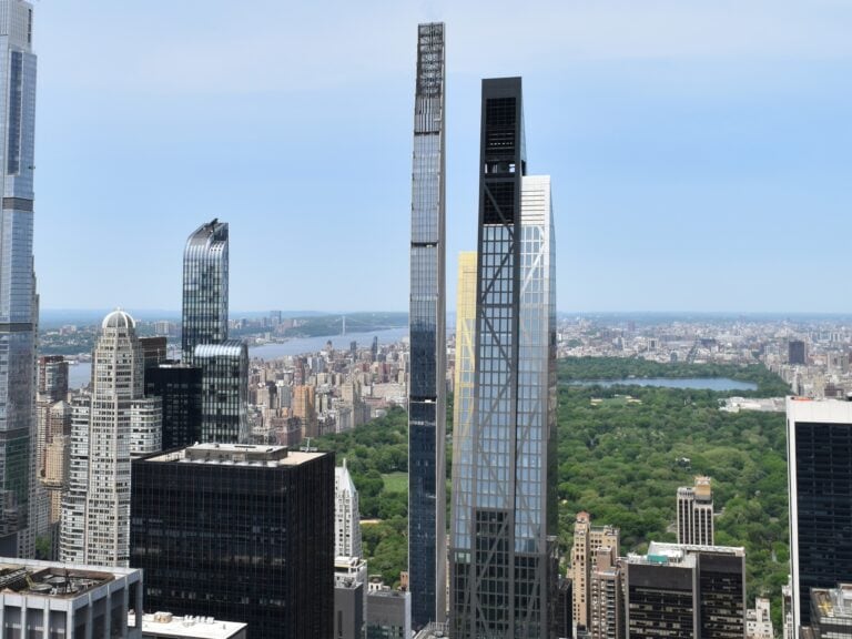 Tall modern skyscrapers overlook Central Park and the cityscape of New York, offering some of the best skyviews in New York under a clear sky.