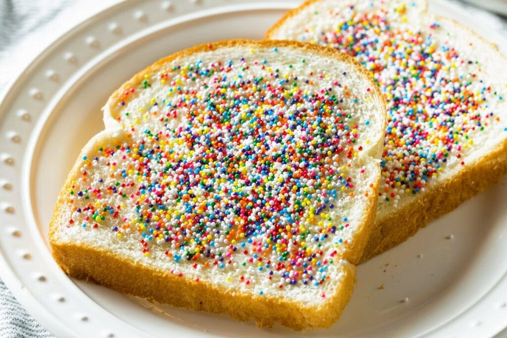 Two slices of bread with sprinkles on them.