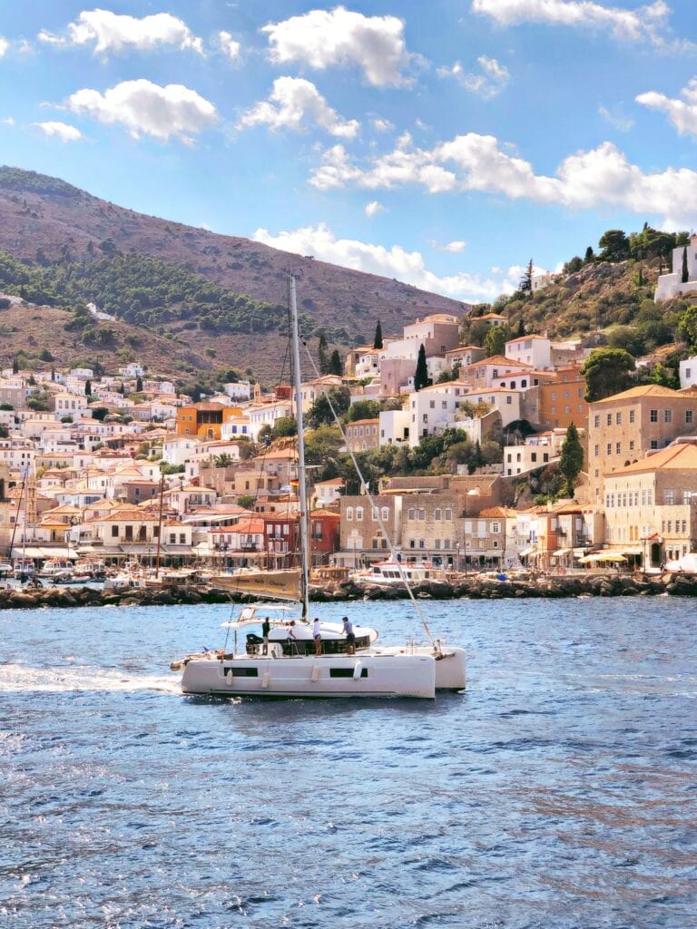 A boat in the water near a town.