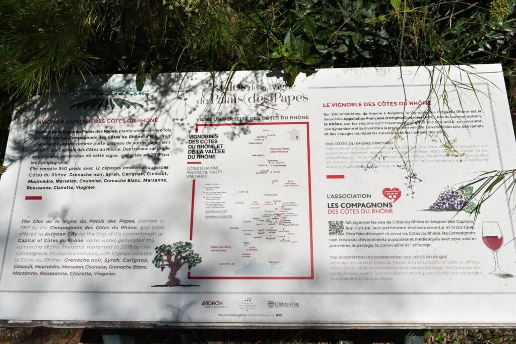 Information board about the Côtes du Rhône wine region, featuring text, a map, and illustrations of grapes and wine—a must do for wine tastings near Avignon.