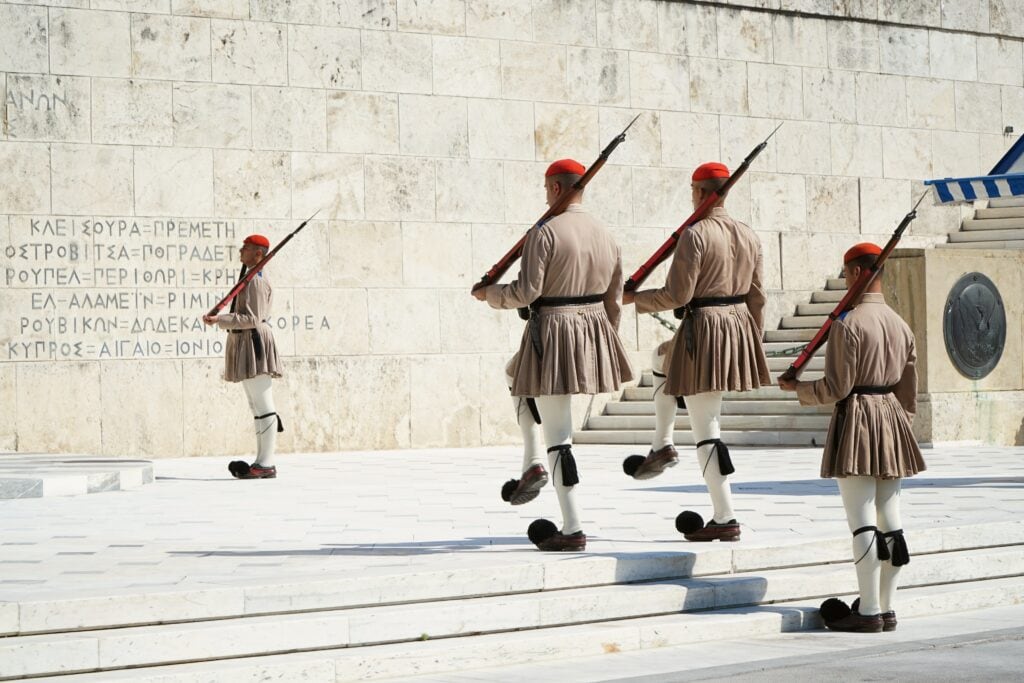 A group of soldiers walking down a set of steps.