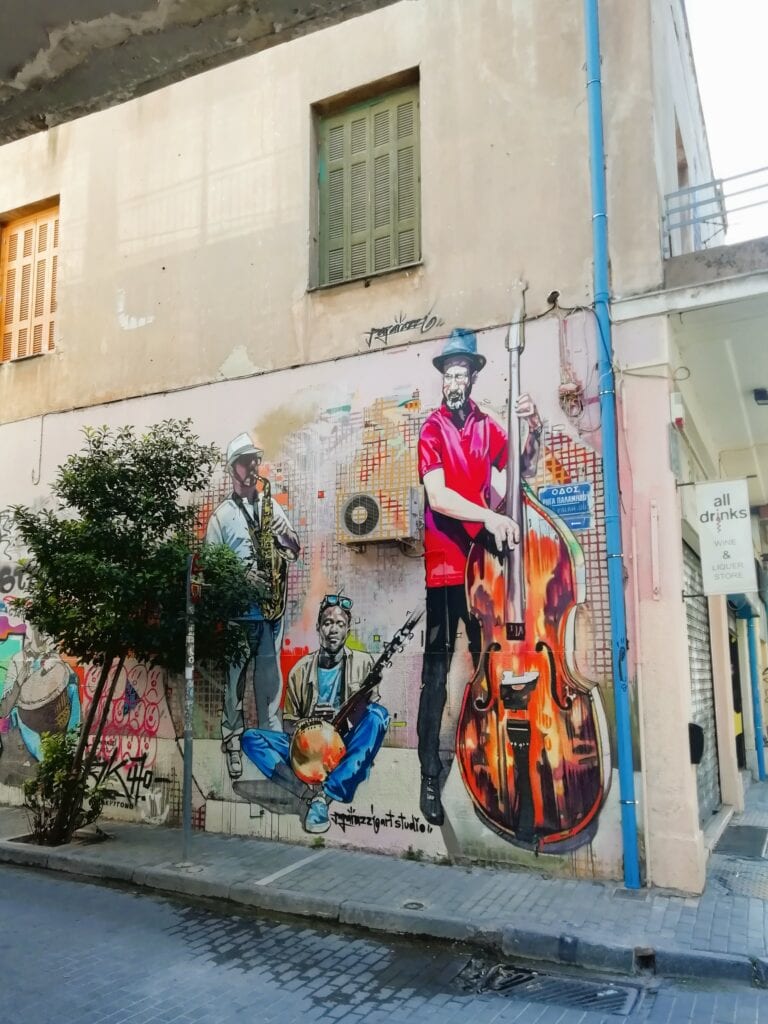 A building with a mural of a man playing a guitar.