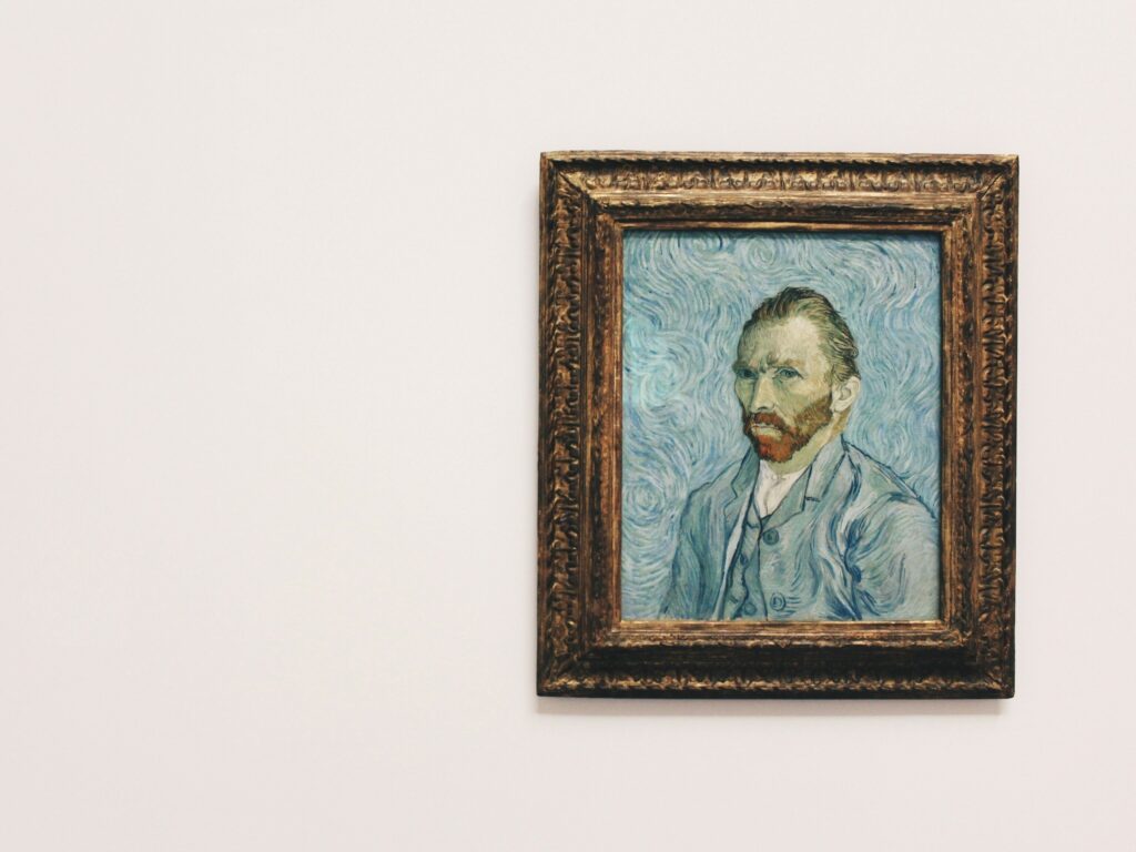A painting of van gogh hanging on a wall.