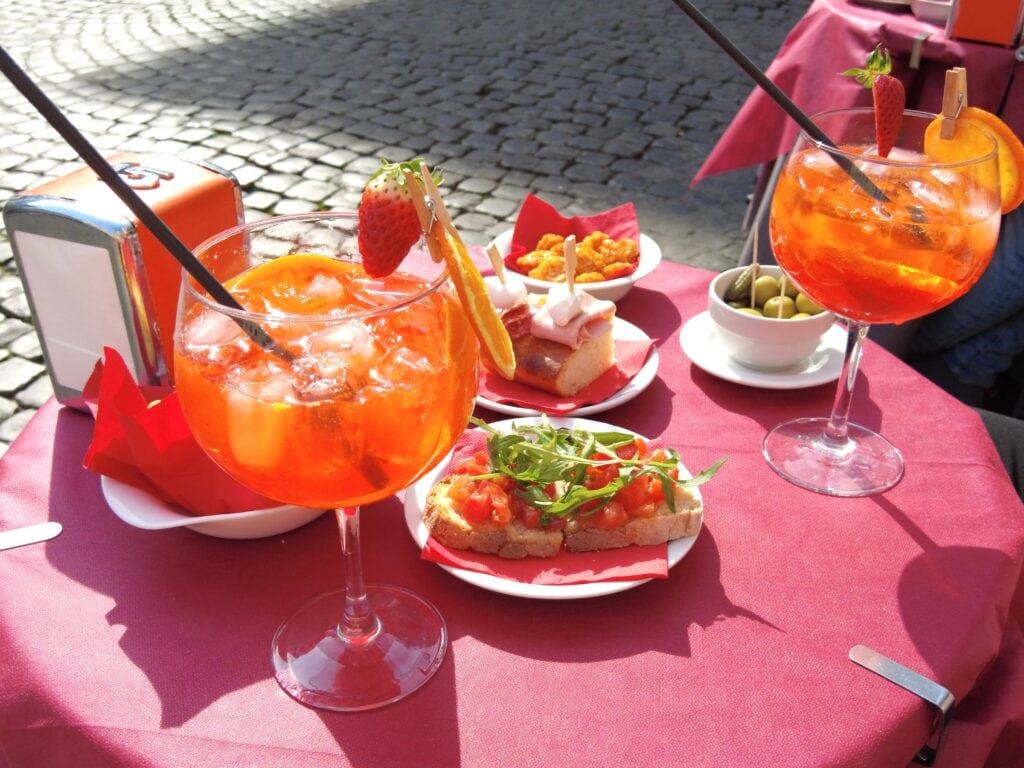 A red tablecloth on the table, perfect for an aperitivo in Rome.