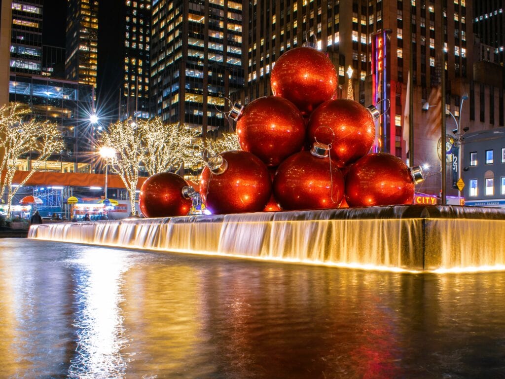 New York City fountain adorned with red Christmas balls, 