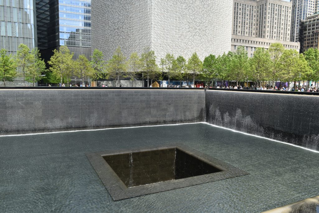 A square reflecting pool with a central void, surrounded by trees and tall buildings in a city plaza—one of 12x the best attractions in New York City (Updated 2025).