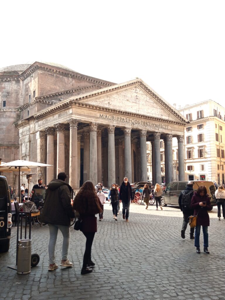 People strolling near the Pantheon, one of the must-see attractions in Rome, on a sunny day.