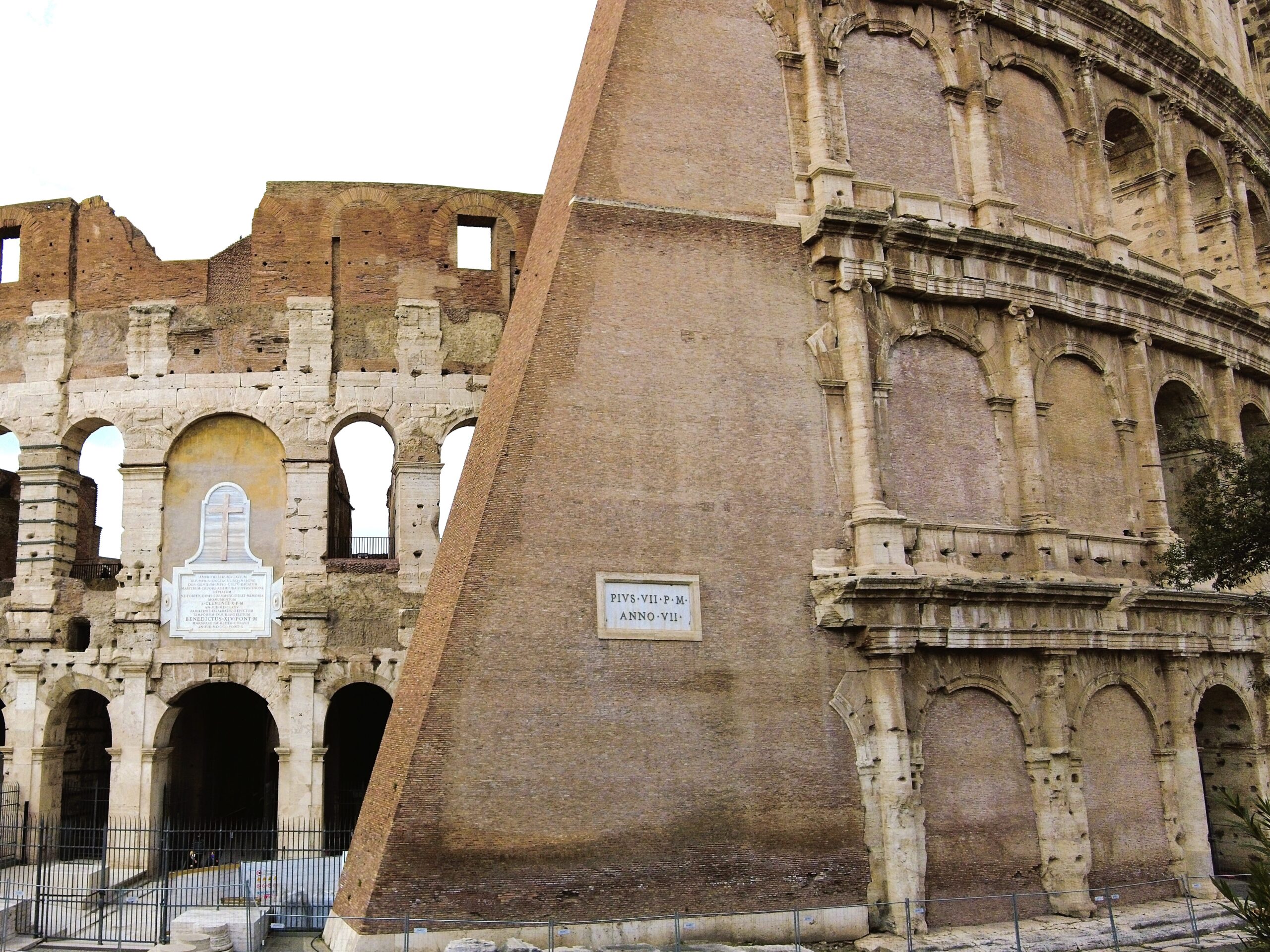 The exterior view of the Colosseum in Rome, a must-see attraction, showcases its ancient stone arches and partially intact structure.