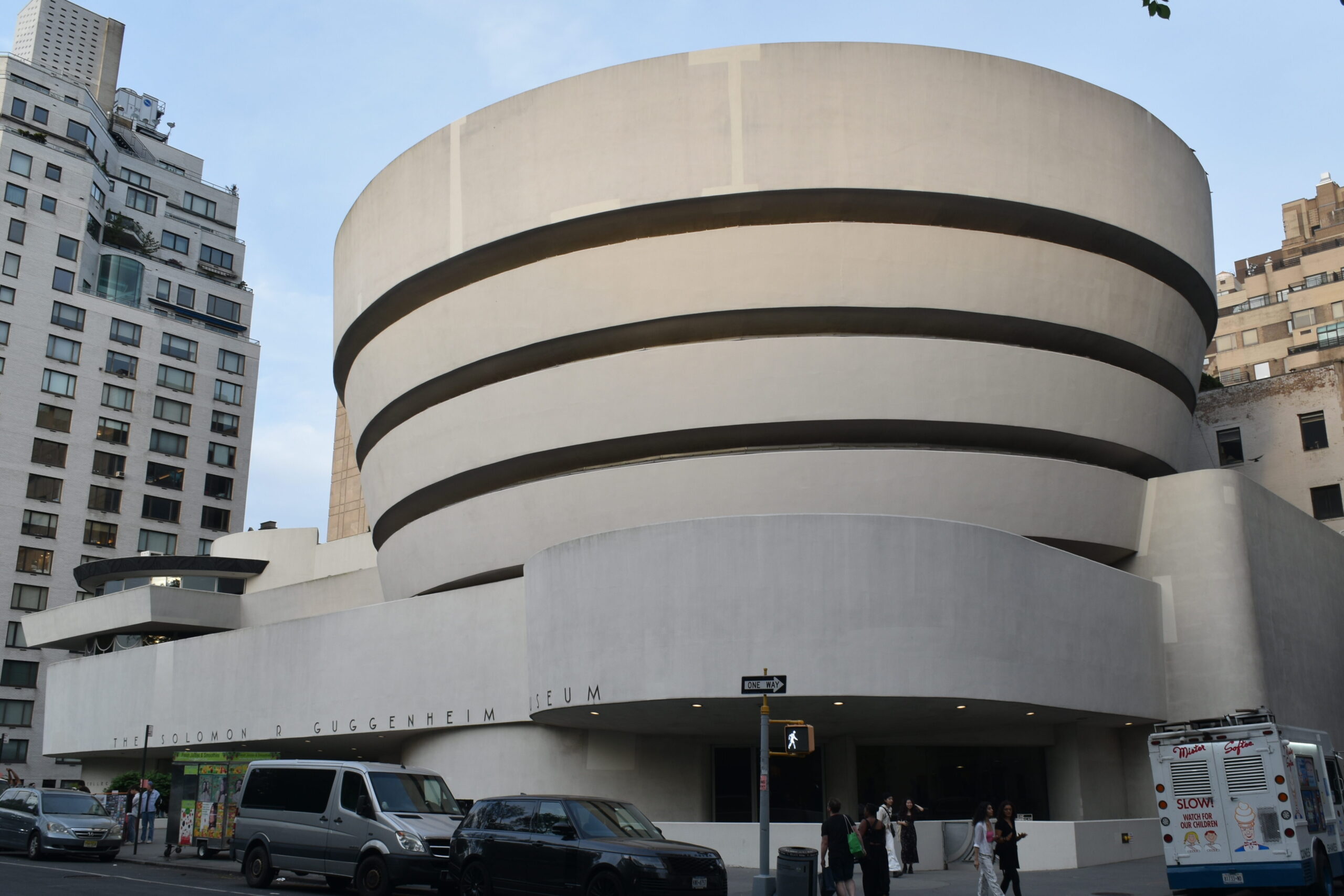 Street view of the Guggenheim Museum in New York, one of the iconic museums in New York, featuring its unique spiral architecture and city backdrop.