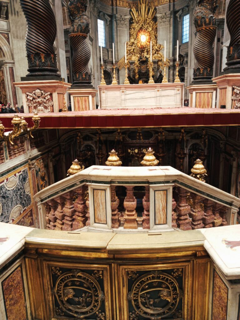 The ornate church interior in Vatican City features a grand altar, spiral columns, and detailed carvings surrounded by decorative railings, offering a mesmerizing experience for those who visit. nct