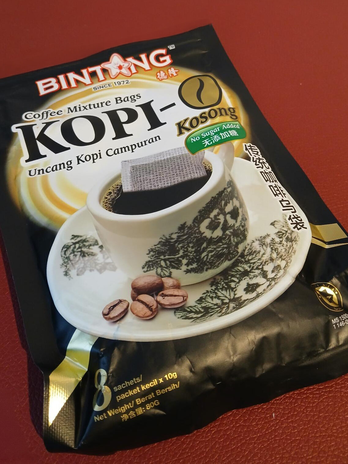 Package of famous Bintang Kopi-O coffee mixture bags on a red surface, capturing the rich flavors reminiscent of Singapore's beloved kopi culture.