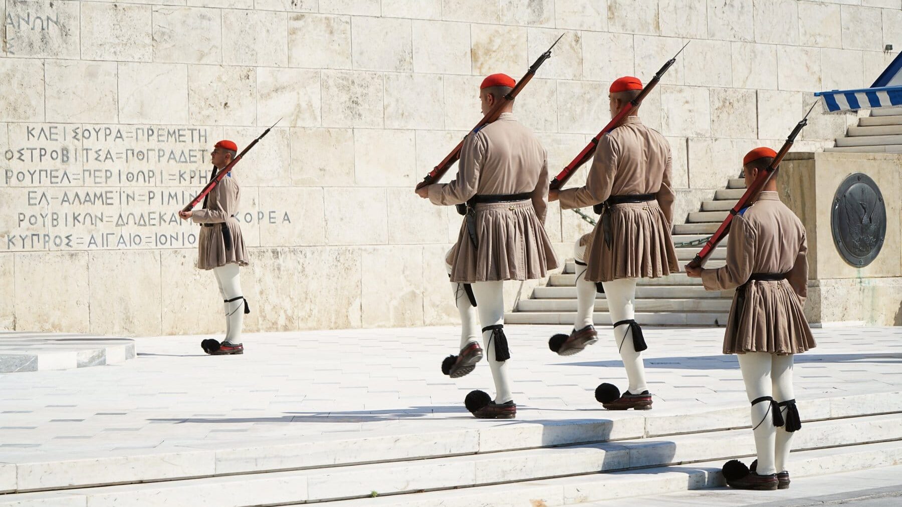 A group of soldiers walking down a set of steps.