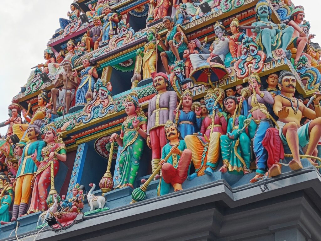 The vibrant, intricate sculptures on this colorful Hindu temple facade make it one of the most popular attractions in Singapore, showcasing numerous figures and ornate details that captivate visitors.