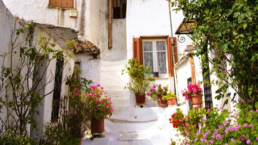 A white building on the side of a hill.