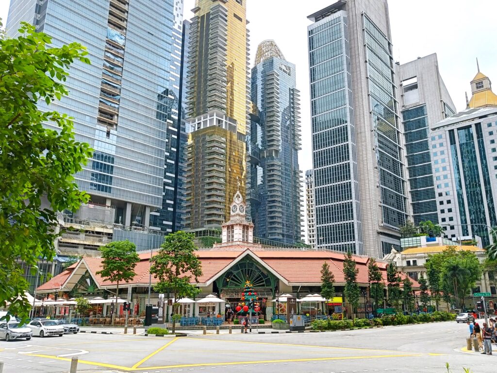 Lau Pa Sat food market, one of the most popular attractions in Singapore, is set against a backdrop of towering skyscrapers and lush greenery.