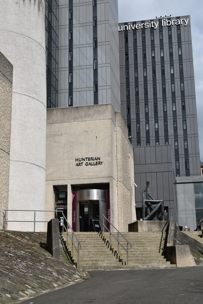 Entrance to the Hunterian Art Gallery, one of the must visit museums in Glasgow, with the university library building in the background.