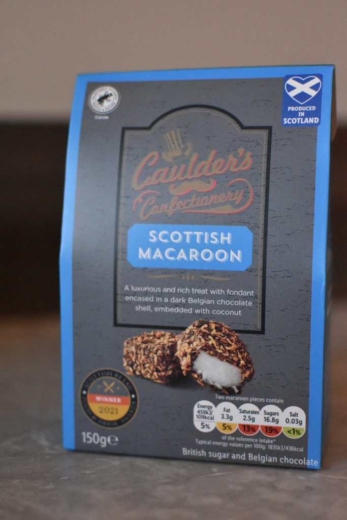 Blue box of Caulder’s Confectionery Scottish Macaroon, showing chocolate-coated coconut treats on the front—a delightful choice among the best food souvenirs from Glasgow.