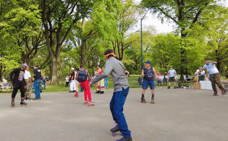 People roller skating outdoors in a park surrounded by green trees on a sunny day—one of the classic Central Park activities and a favorite among things to do in Central Park.