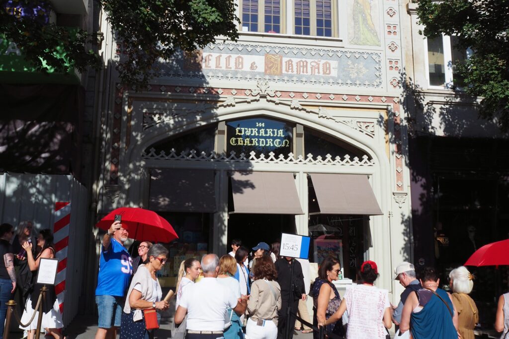 A crowd queues outside the ornate Livraria Lello bookshop in Porto on a sunny day—one of the most popular attractions in Porto and a must-see for anyone wondering what to do in Porto.